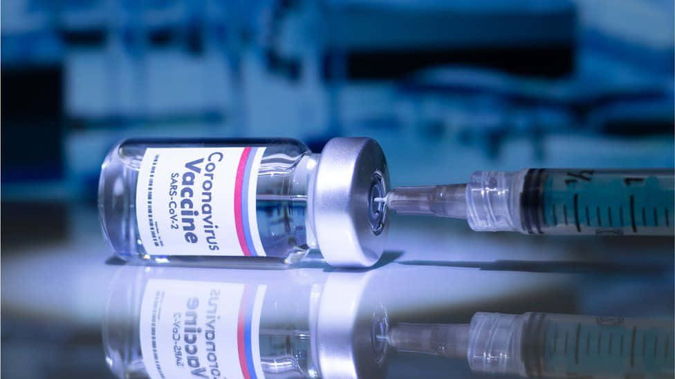 Syringe Inserted In A Vial Coronavirus Vaccine Wallpaper