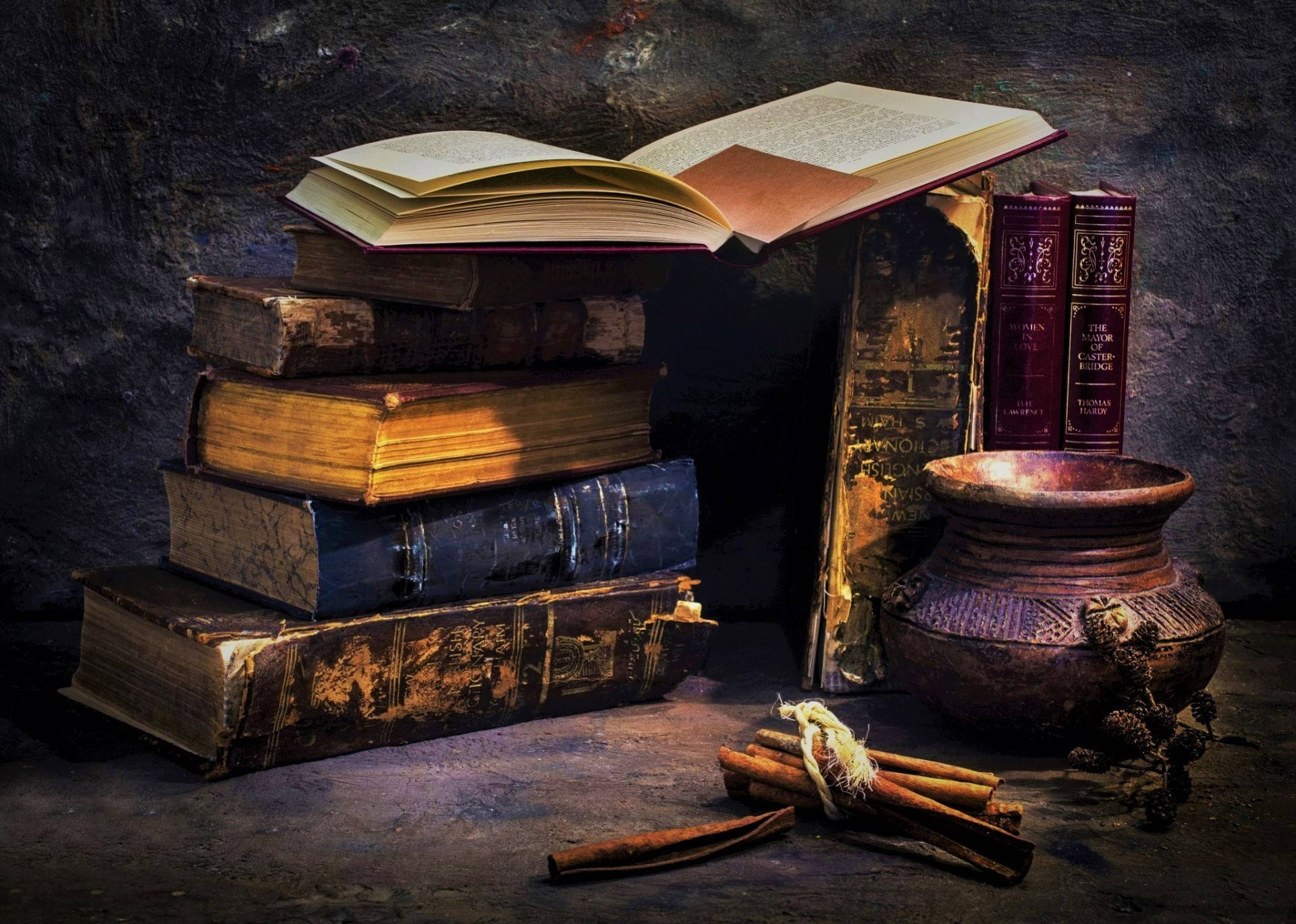 Vintage Bowl Accompanied by Aged Books Wallpaper