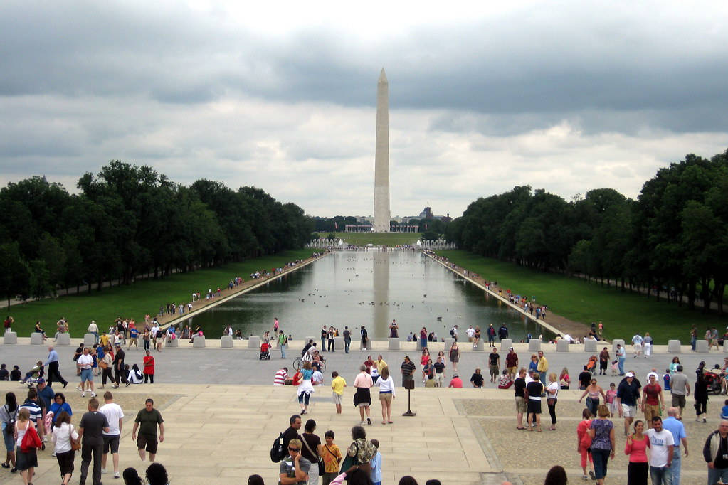Captivating View of the Washington Monument Surrounded by Tourists Wallpaper