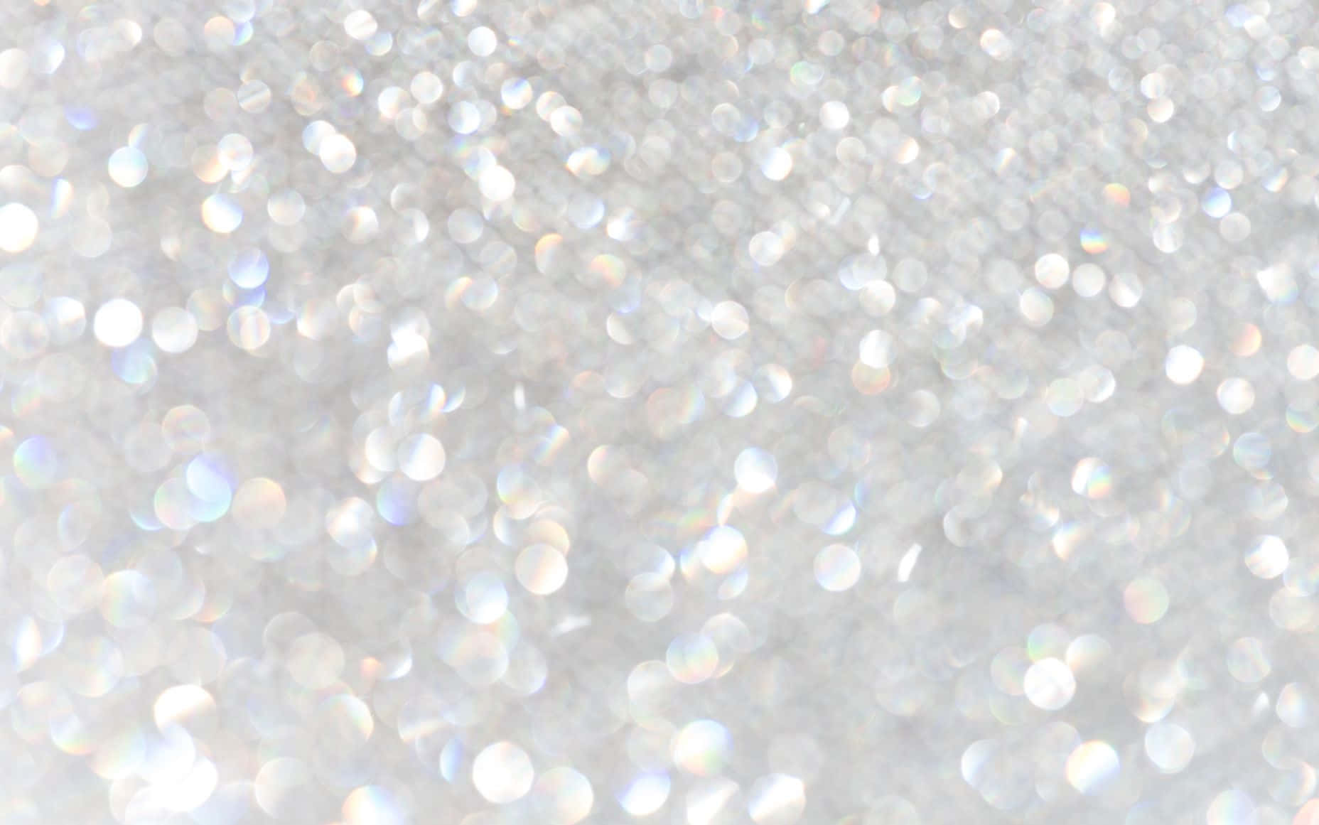 Gold and Silver Glitter Against a White Background Wallpaper