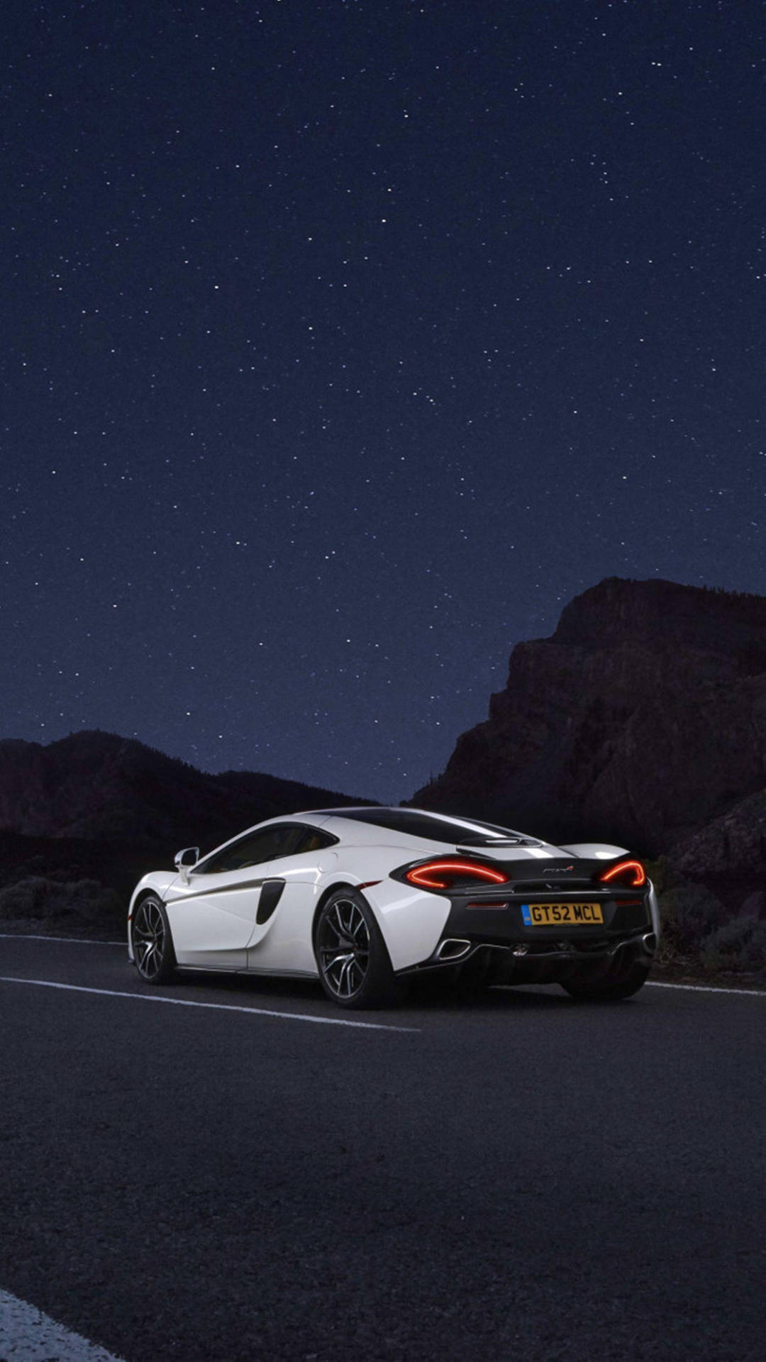 Caption: "Stunning White McLaren Against Dark Aesthetic Backdrop" Wallpaper