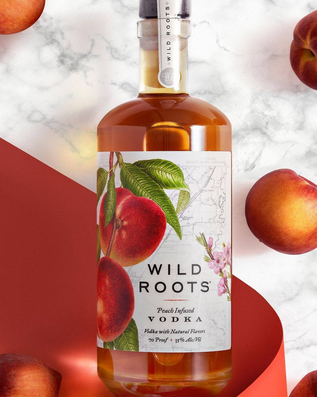 Wild Roots' Huckleberry-Infused Vodka Bottle Showcasing Natural Ingredients Wallpaper